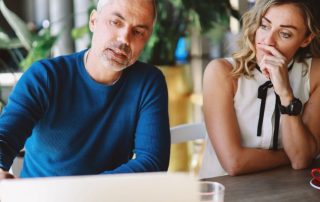 couple with laptop considering early retirement