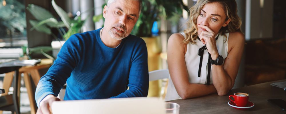 couple with laptop considering early retirement