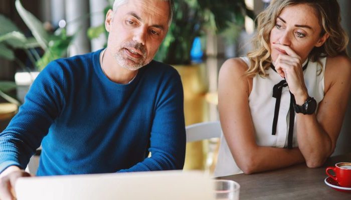 couple reviewing laptop early retirement options